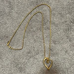 Long brass colored necklace with heart from New York and Company.